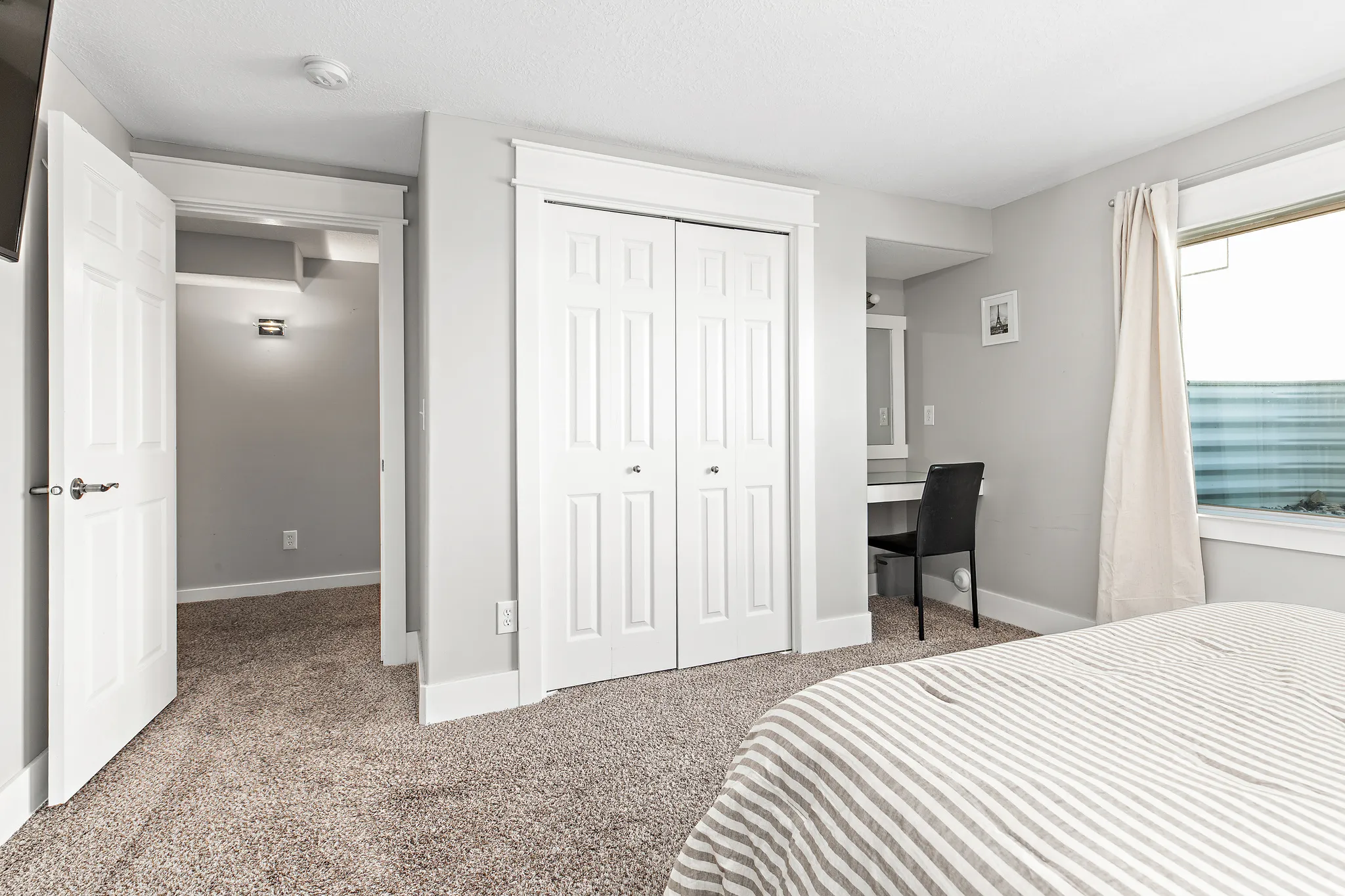 Plush carpeting, bi-fold closet doors, built-in desk area, recessed lighting, and a large window