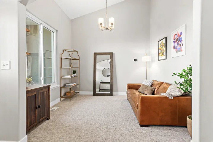 Bright, open foyer featuring soaring vaulted ceilings, recessed lighting, and neutral wall finishes