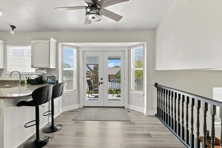 Wood-finish flooring with a ceiling fan overhead