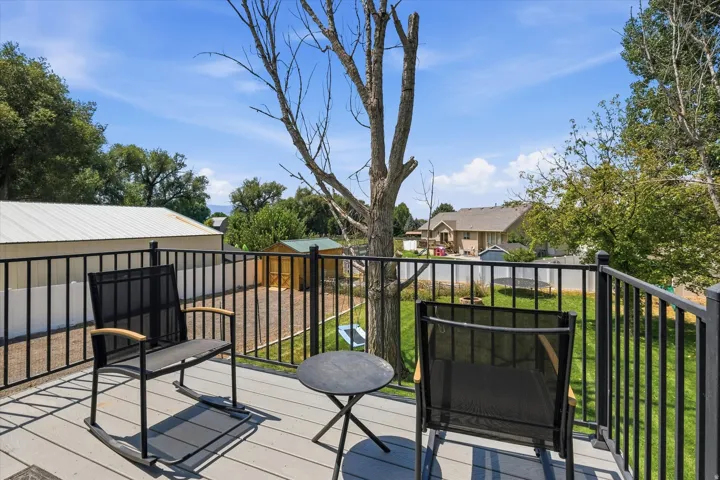Outdoor deck featuring composite decking and black metal railings