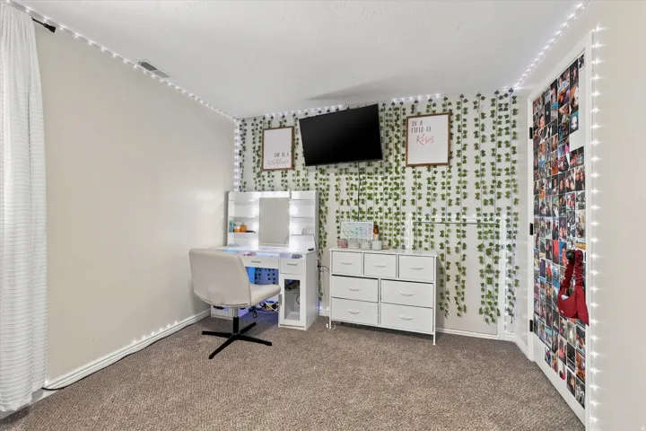Wall-to-wall carpeting and white window treatments