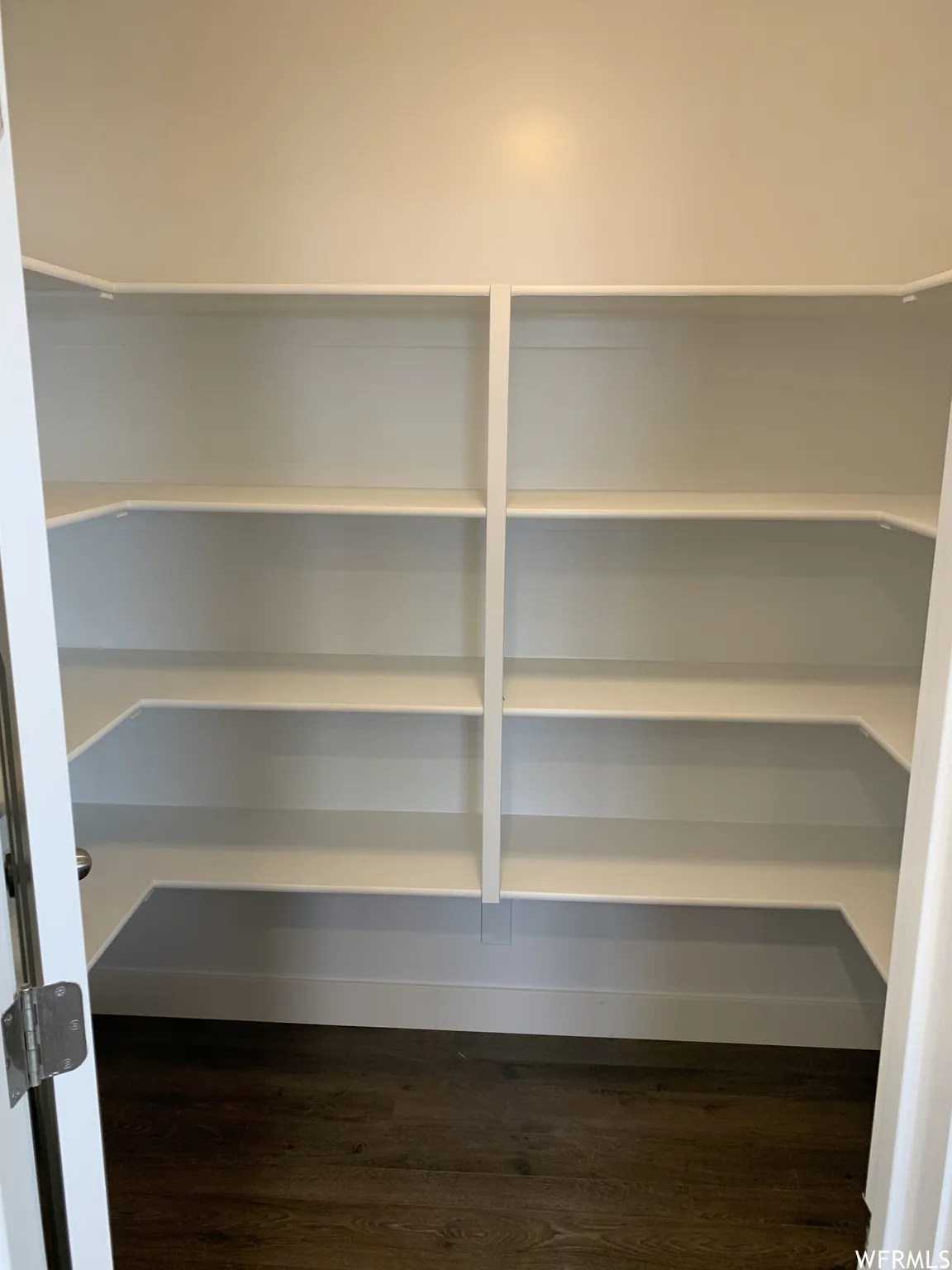 Built-in shelving, durable wood-finish flooring, and crisp white trim