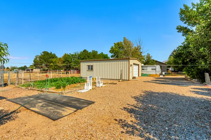 Metal-sided outbuilding with garage door and window
