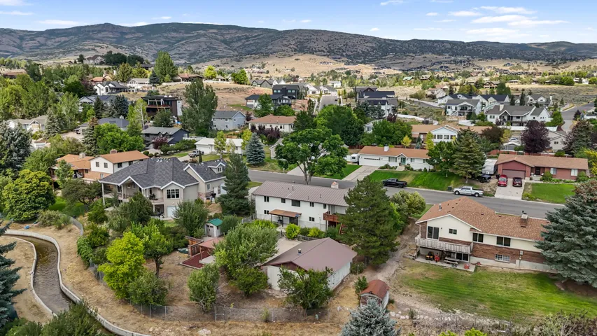 Neighborhood setting with mature trees and a meandering water channel