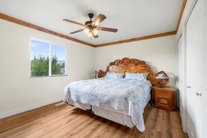 Master Bedroom - Wood-finish flooring, white walls, and a large window with views of Mt Timpanogos