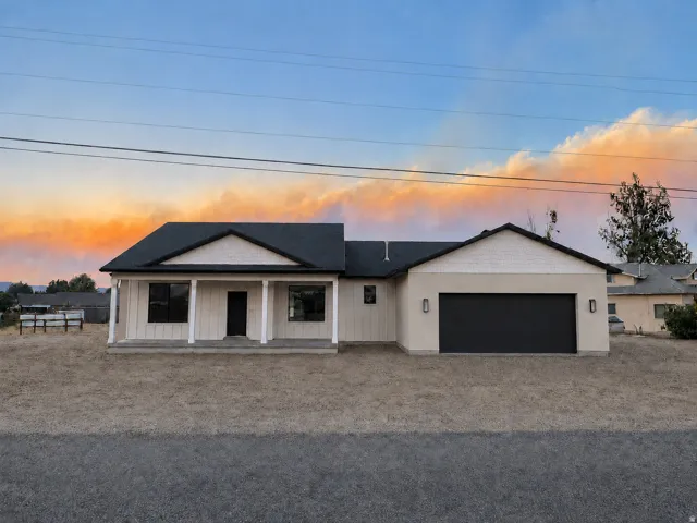 Single-story residence featuring a two-car garage, and a covered porch