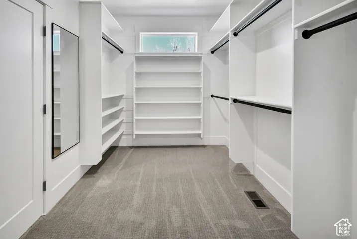 Built-in shelving, integrated hanging rods, and a window for natural light