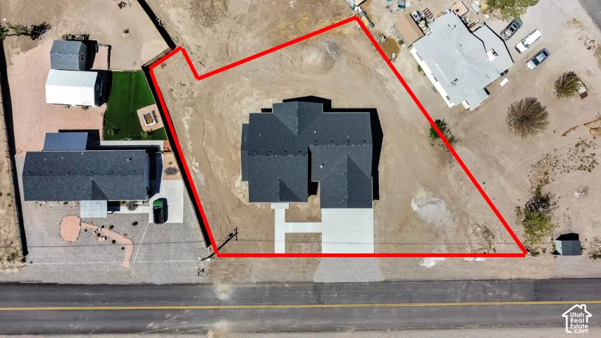 Lines are approximate. New construction featuring a dark shingle roof, concrete driveway, and an expansive lot