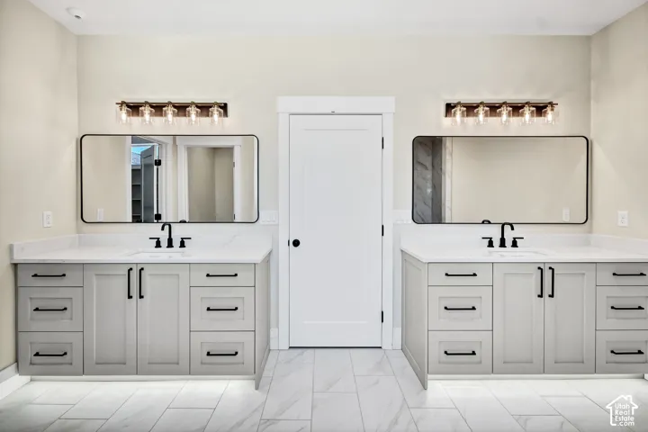 Dual vanities with undermount sinks, quartz countertops, and matte black fixtures