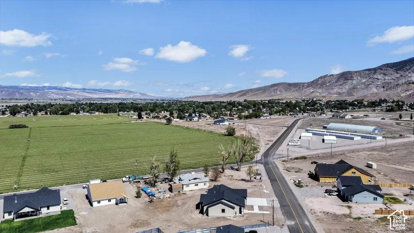 Rural setting featuring distant mountains and expansive green fields