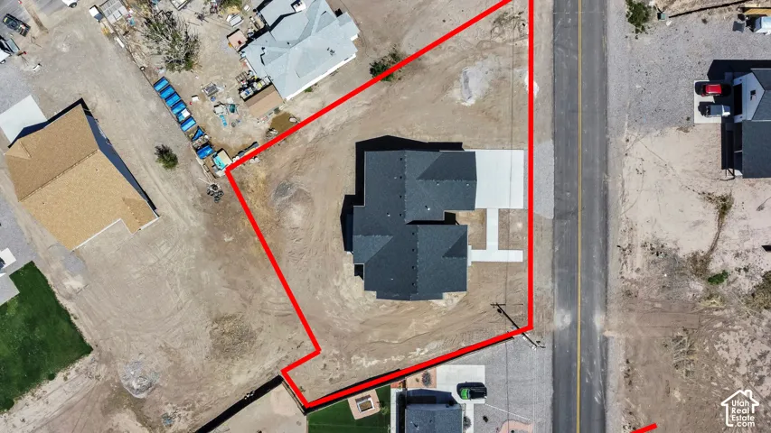 Lines are approximate. Newly constructed residence with a dark shingle roof and a concrete driveway