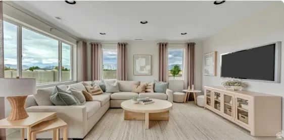 Recessed lighting, large windows, light wood-finish flooring, built-in media console, and built-in wall cabinets. This home is under construction. Pictures are of a similar home.