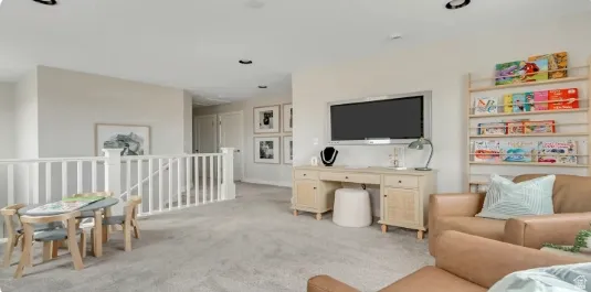 Carpeted bonus room featuring a built-in media console and recessed lighting. This home is under construction. Pictures are of a similar home.