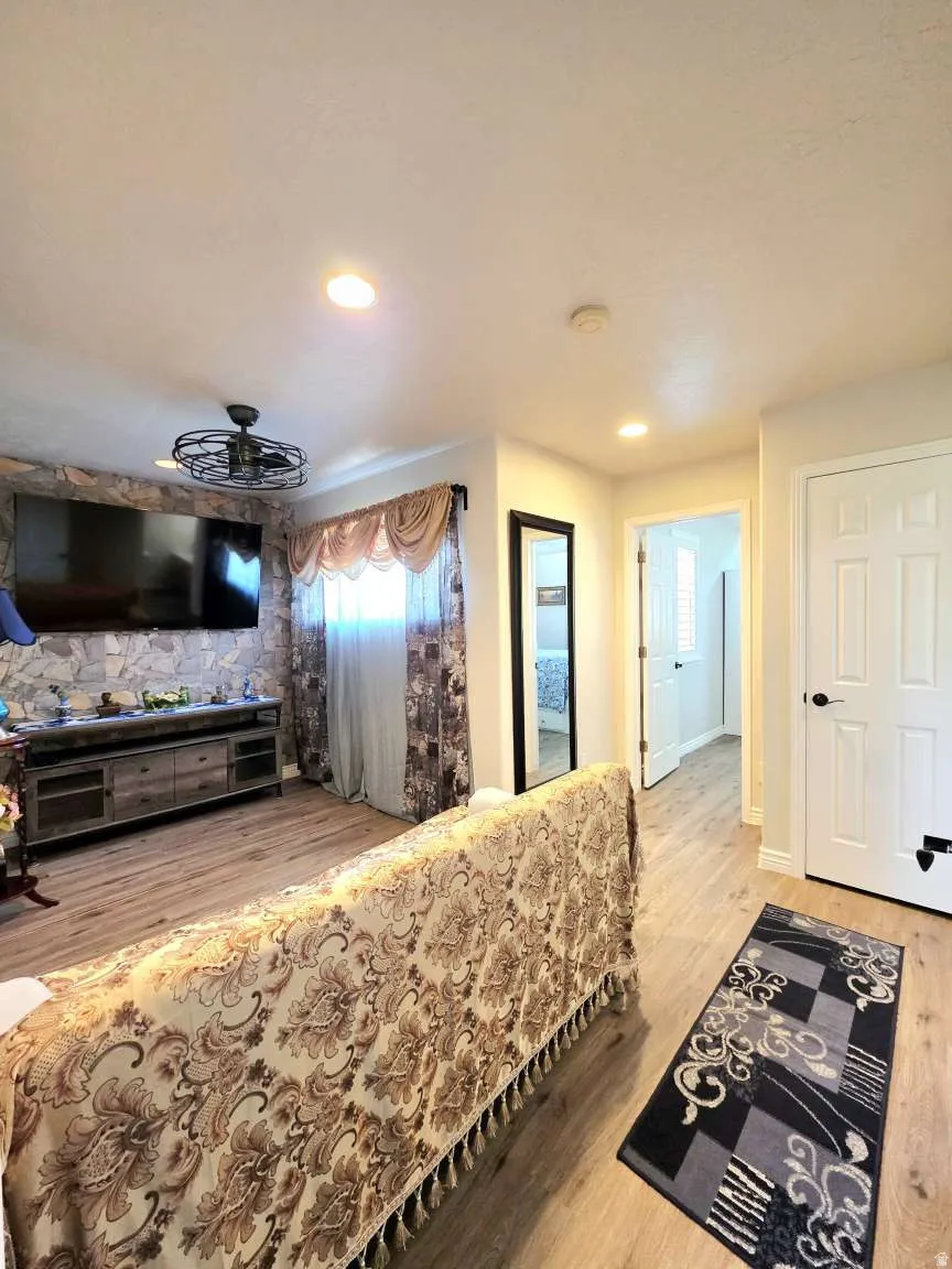 Recessed lighting illuminates wood-finish flooring