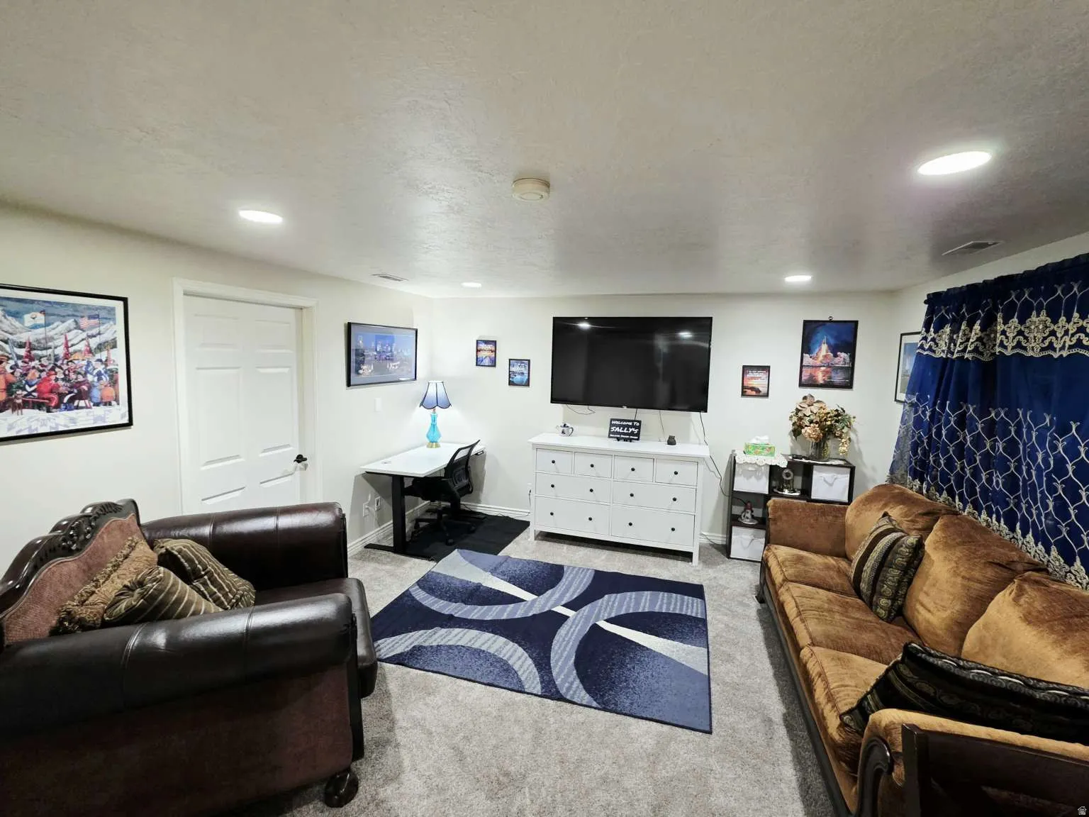 Carpeted room with recessed lighting, white walls, and a white interior door