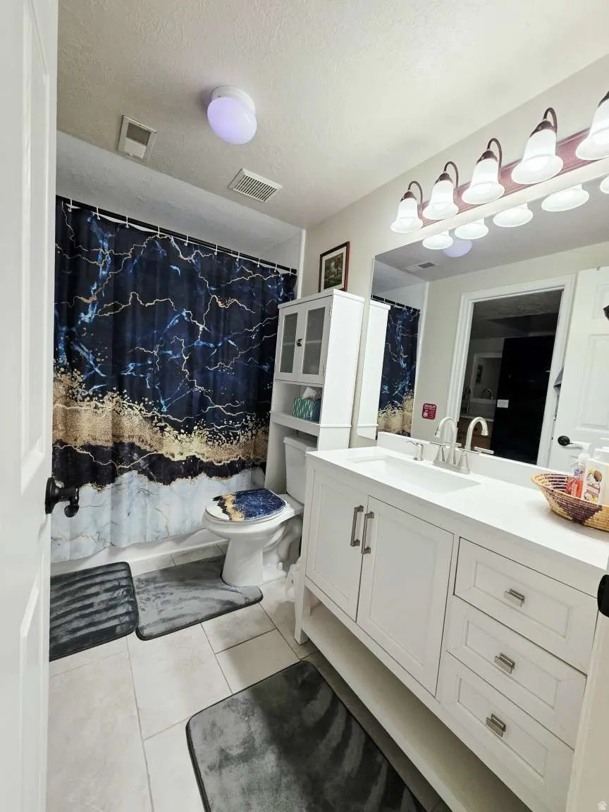White shaker-style vanity with integrated sink, brushed nickel hardware, and a matching full-width mirror