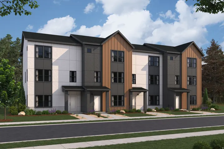 Contemporary townhome exterior featuring multi-toned siding, black-framed windows, and a dark shingle roof