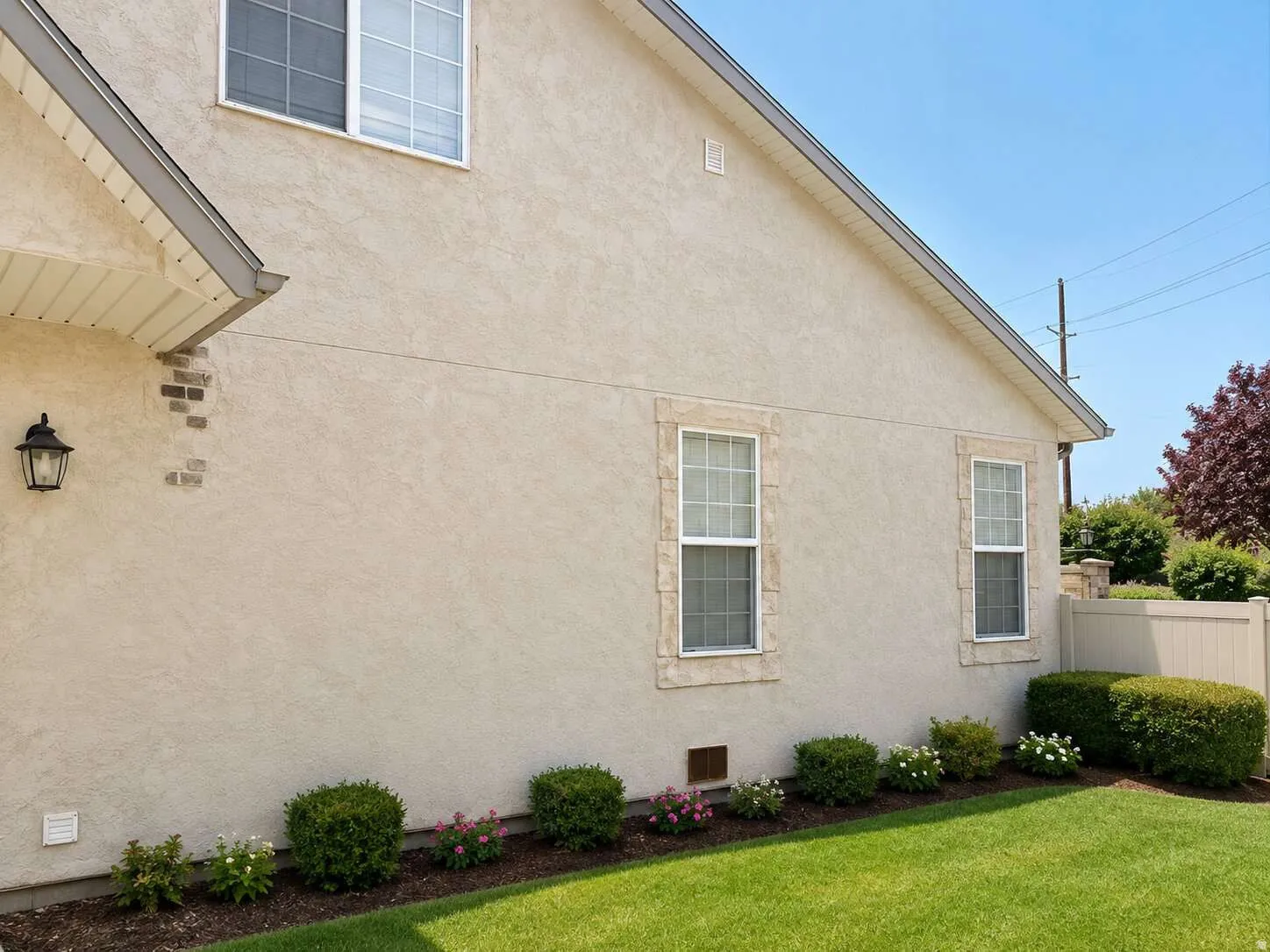 Stucco exterior with brick accents and stone-framed windows