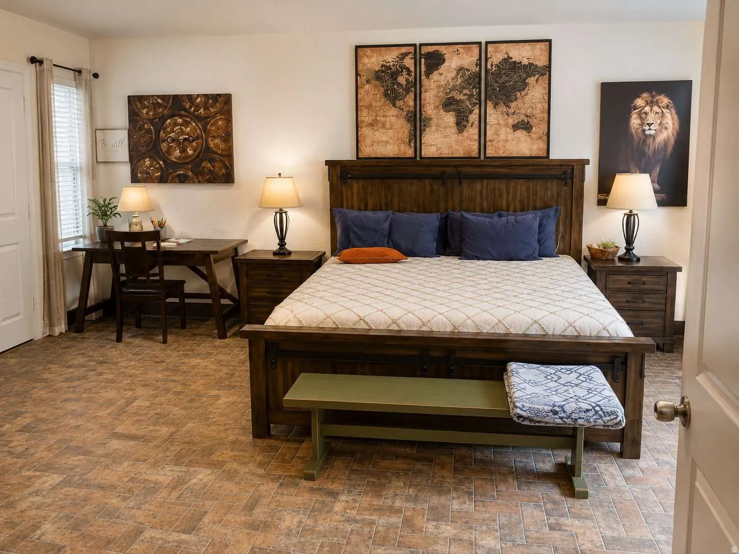 Wood-finish flooring throughout, featuring a window with blinds, a solid core door, and a built-in wood bed frame with matching nightstands