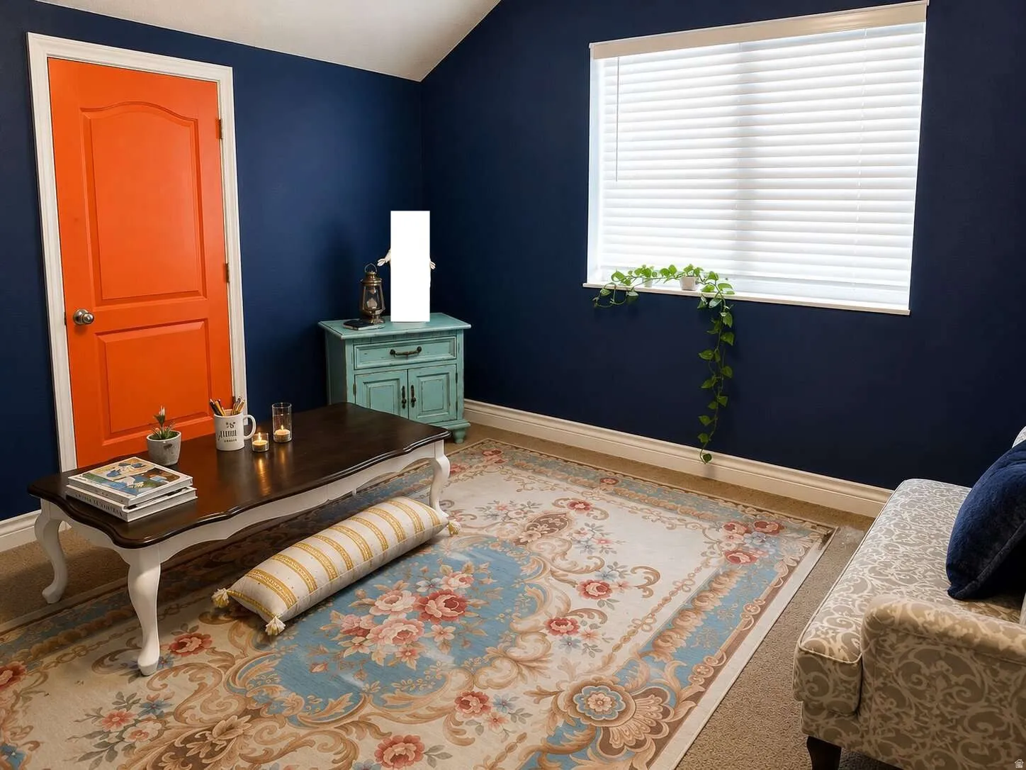 Carpeted room with a vaulted ceiling, a single window featuring blinds, and an orange paneled door