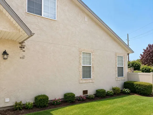 Stucco exterior with brick accents and stone-framed windows