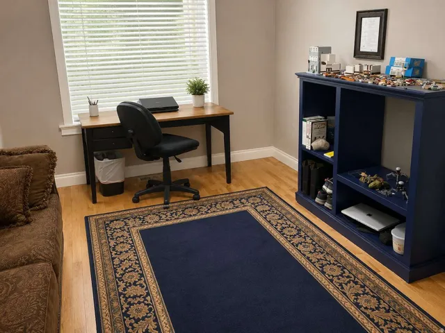 Light wood-finish flooring, built-in shelving, and a prominent window with blinds
