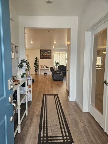 Entryway featuring wood-finish flooring, white walls, and recessed lighting