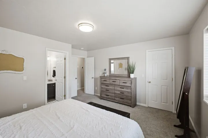 Carpeted room with light neutral wall paint, overhead flush-mount lighting, and white six-panel doors