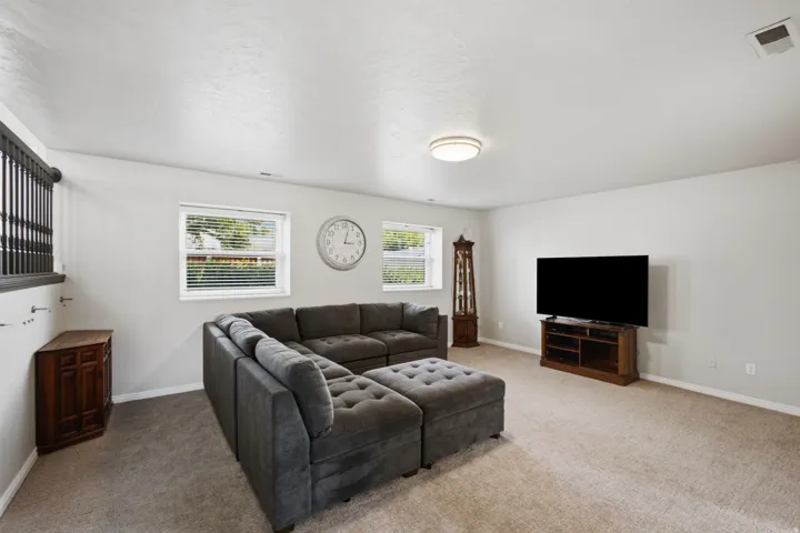 Recessed windows with blinds, carpeted flooring, and a flush-mount ceiling light