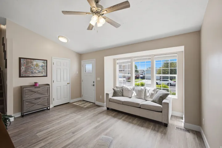 Wood-finish flooring, recessed lighting, and a ceiling fan with light kit