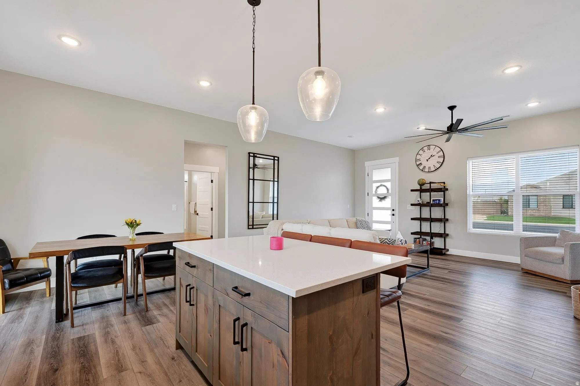 Kitchen island with white countertop and wood-finish cabinetry
