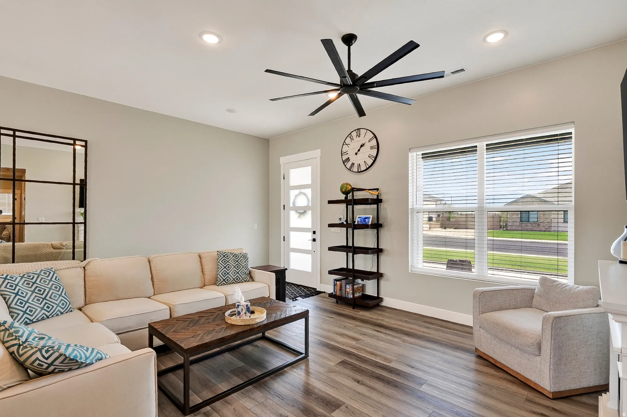 Wood-finish flooring throughout, recessed lighting, and a modern ceiling fan