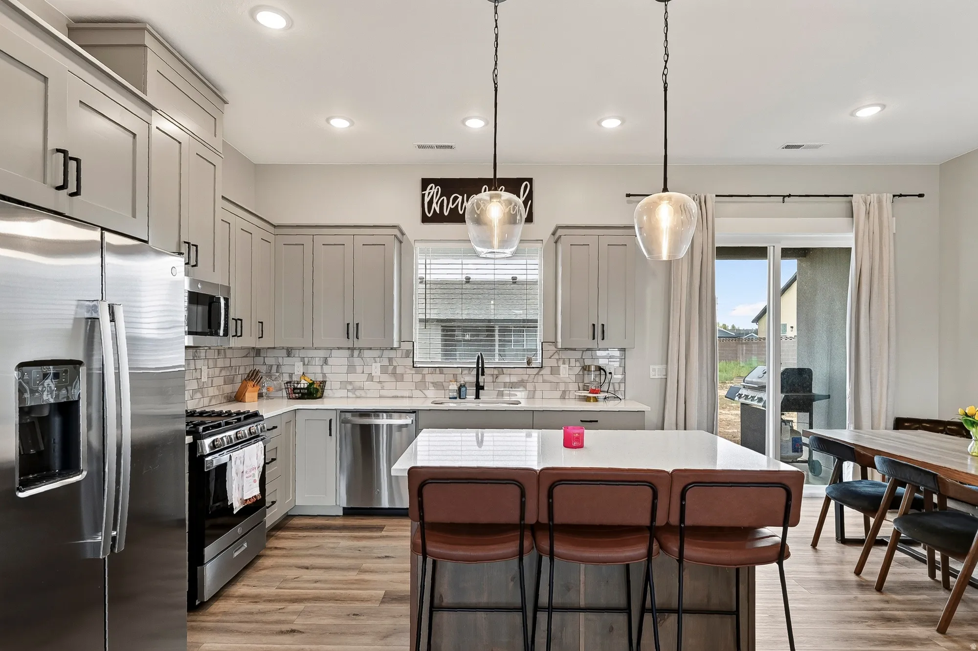 Kitchen featuring shaker-style cabinetry, recessed lighting, and a white countertop island