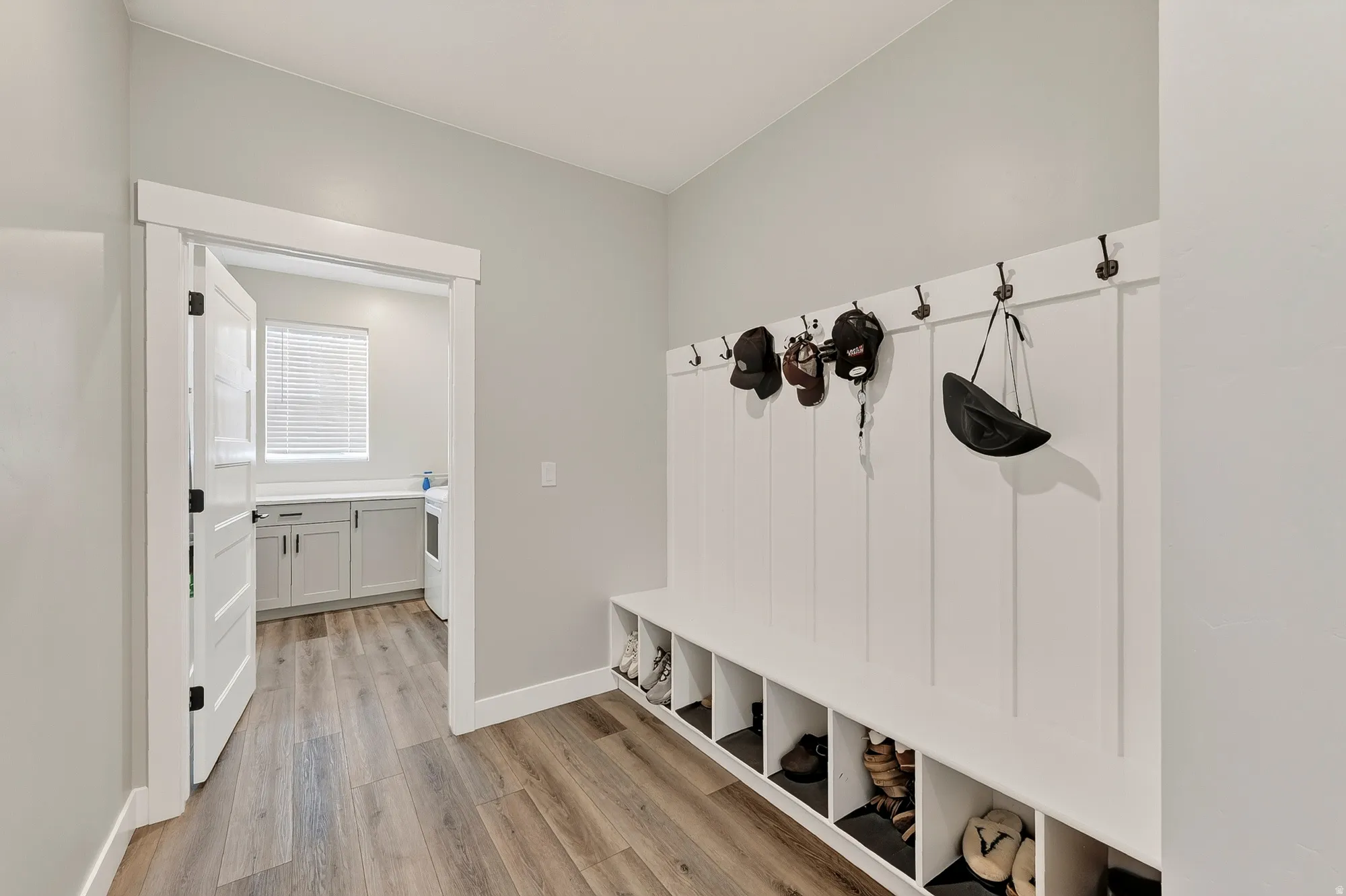 Built-in storage bench with individual cubbies and wall-mounted hooks