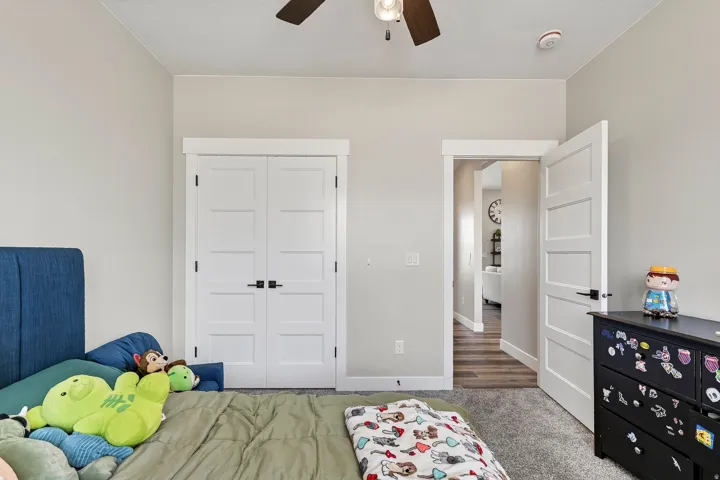 Carpeted flooring, white painted walls, white trim, and a ceiling fan with integrated lighting