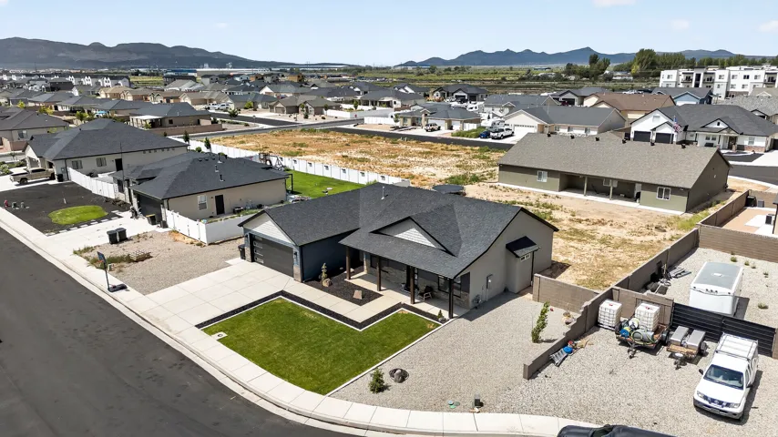 Contemporary single-story residence featuring an attached garage, covered front entry, and a manicured front lawn