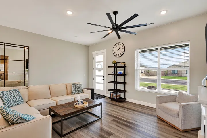 Wood-finish flooring throughout, recessed lighting, and a modern ceiling fan