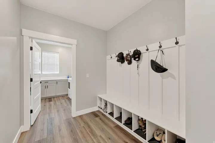 Built-in storage bench with individual cubbies and wall-mounted hooks