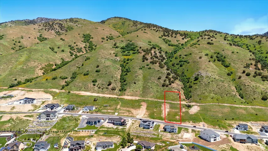 Expansive lot featuring a mountainous backdrop, cleared land, and direct road frontage
