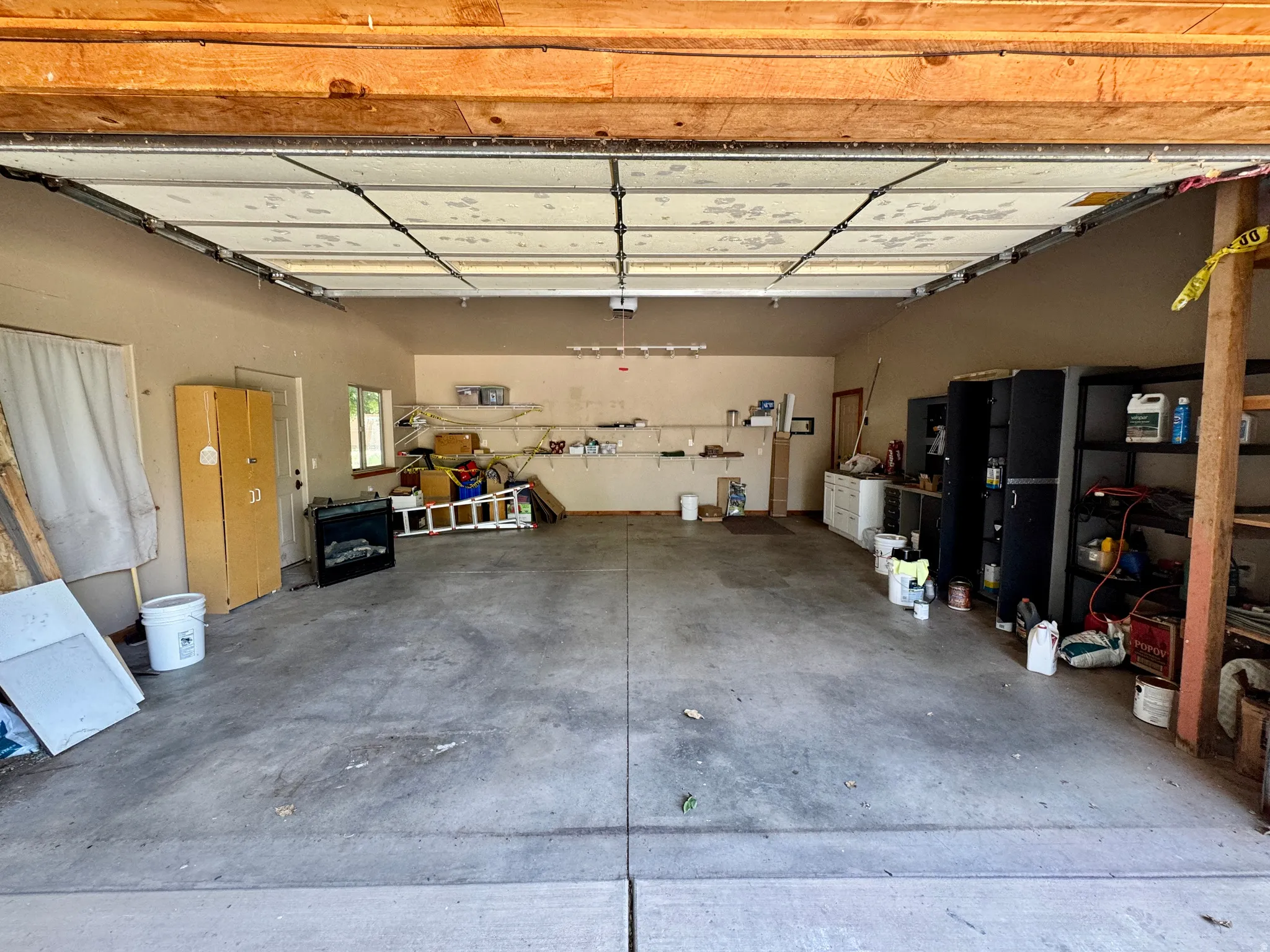 Concrete flooring with exposed ceiling beams and painted walls