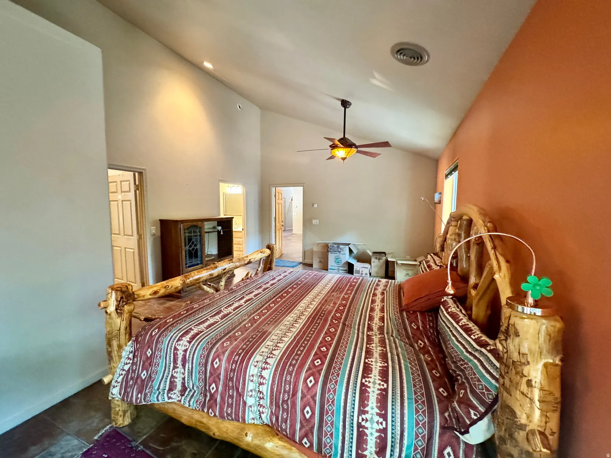 Vaulted ceilings with a ceiling fan, recessed lighting, and a window