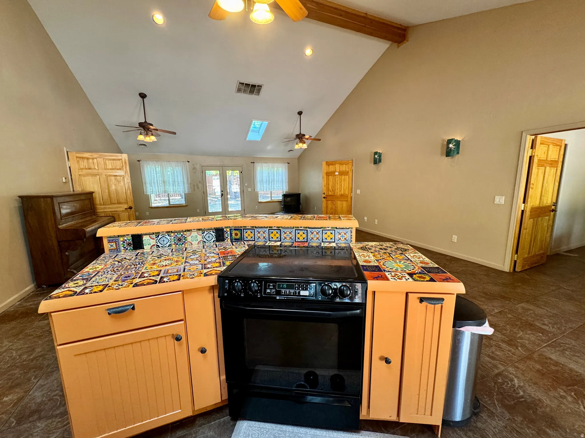 Vaulted ceilings, exposed wood beam, skylight, and recessed lighting
