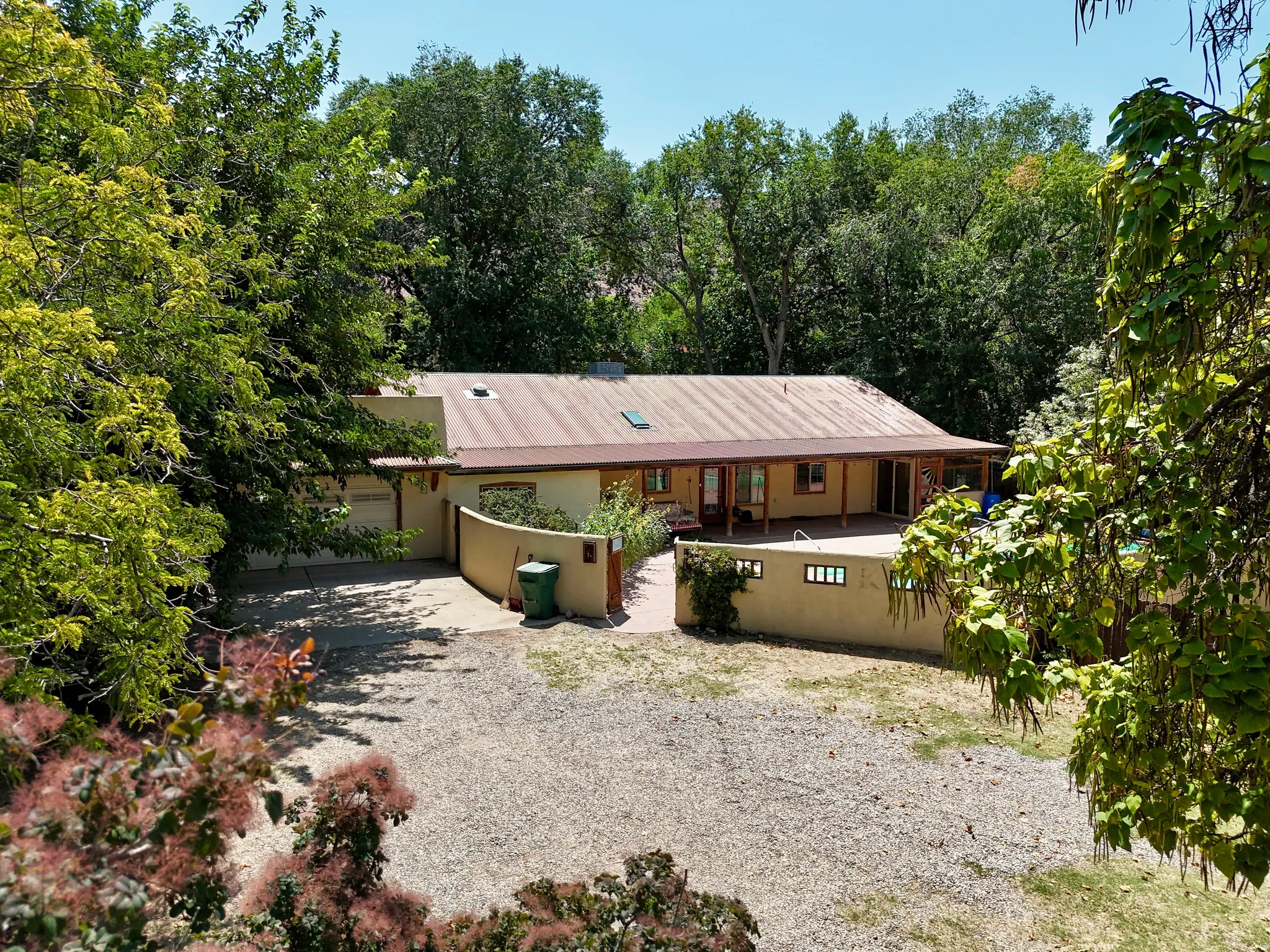 Single-story stucco exterior with a metal roof