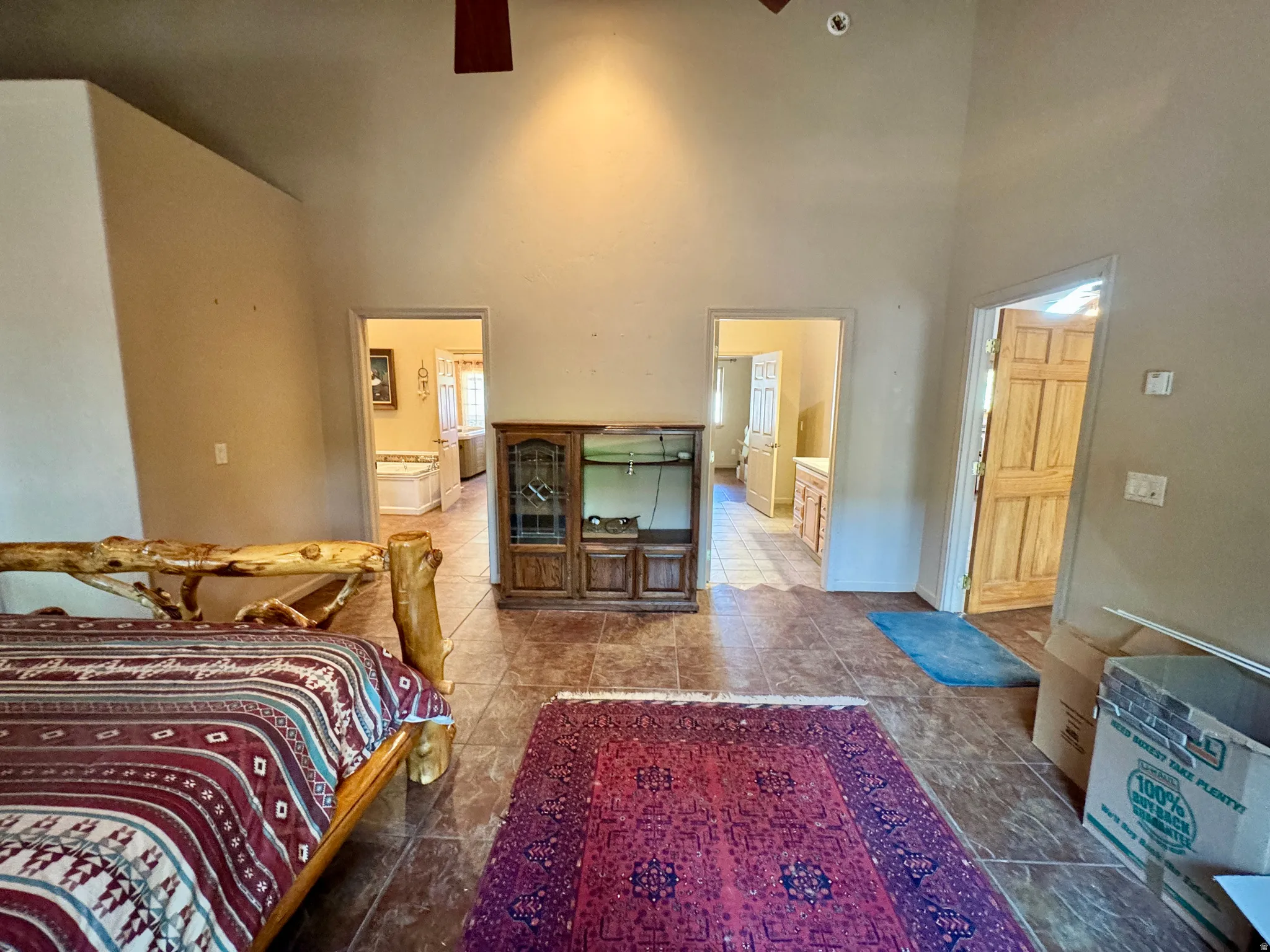 Vaulted ceilings, tiled flooring, wood-finish doors, and multiple room entryways
