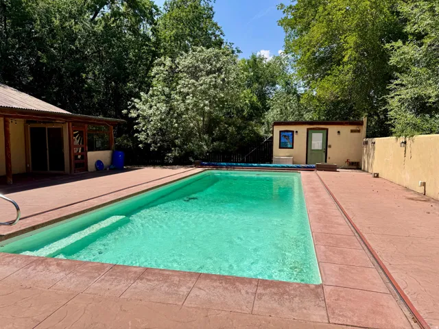 Expansive outdoor pool with integrated steps, surrounded by stamped concrete decking