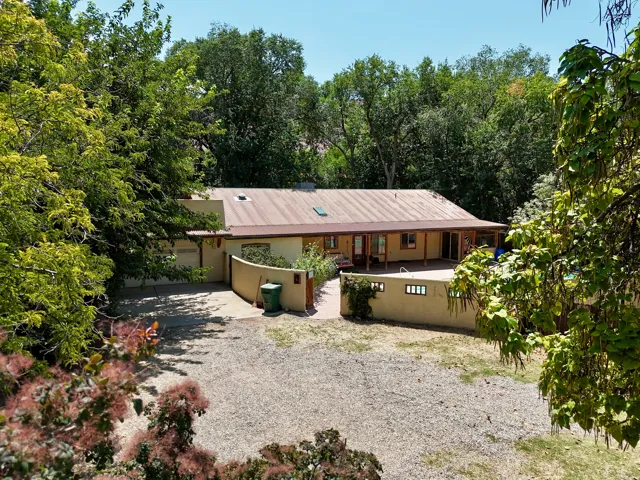 Single-story stucco exterior with a metal roof