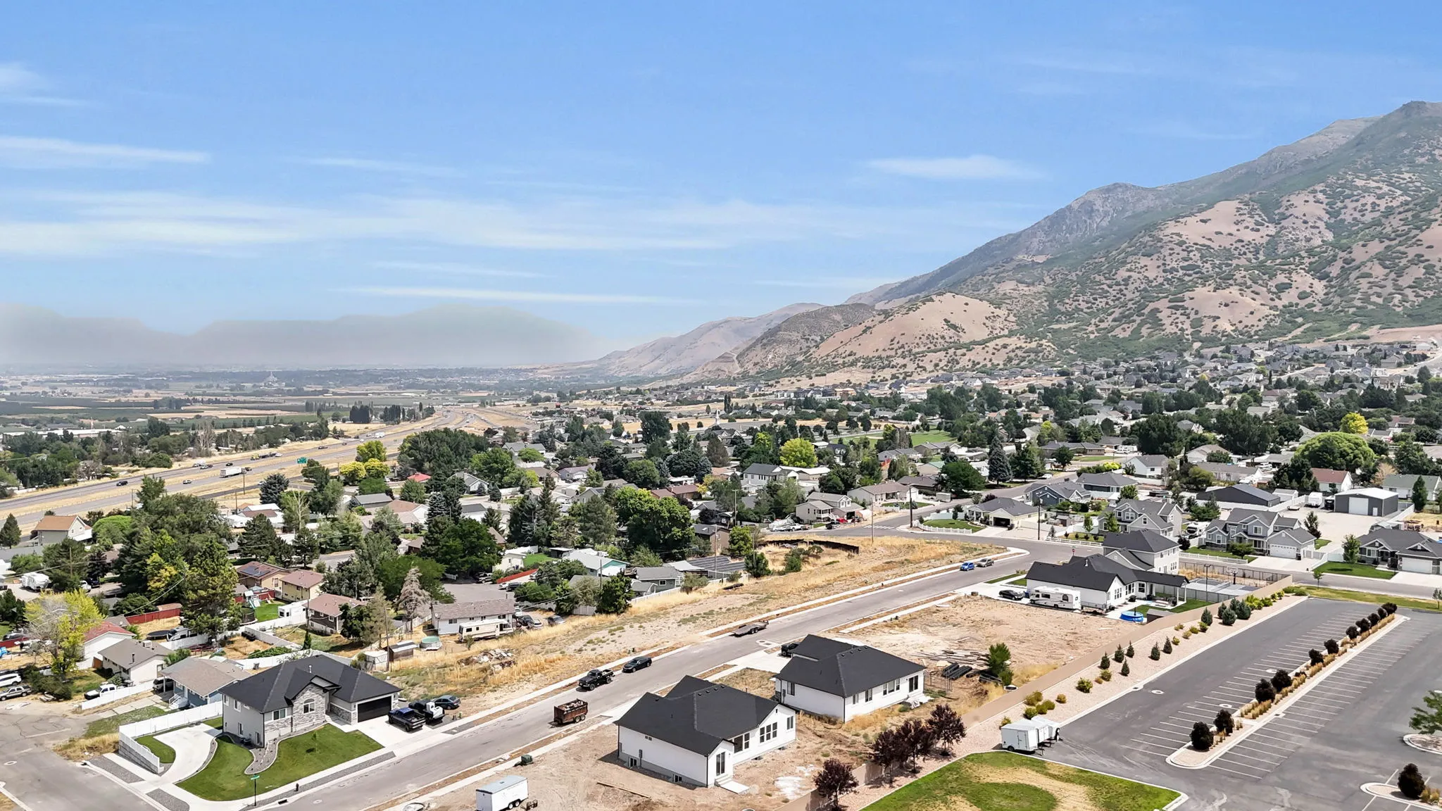 Expansive neighborhood setting with mountain backdrop and established residential properties