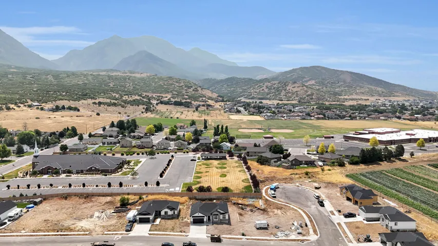 Mountain backdrop, residential development, established community infrastructure, agricultural areas, open spaces