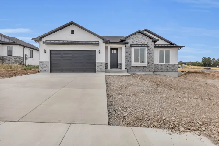 Contemporary exterior featuring a combination of light stucco and stone veneer accents