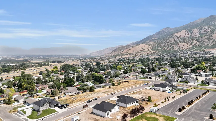Expansive neighborhood setting with mountain backdrop and established residential properties